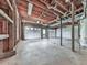 Unfinished basement with exposed ceiling, a garage door, and concrete floor at 423 Eagle Ridge Trl, Canton, GA 30114