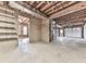 Unfinished basement with concrete floor and walls, exposed utilities, and access to an adjacent room at 423 Eagle Ridge Trl, Canton, GA 30114