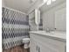Bright bathroom features a white vanity, patterned shower curtain, and neutral wall color at 423 Eagle Ridge Trl, Canton, GA 30114