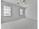 Spacious bedroom features neutral walls, carpeted floors, and two windows providing natural light at 423 Eagle Ridge Trl, Canton, GA 30114
