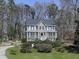 Beautiful two-story home with a charming front porch surrounded by mature trees at 423 Eagle Ridge Trl, Canton, GA 30114