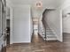 Bright foyer with hardwood floors, staircase, and elegant lighting at 423 Eagle Ridge Trl, Canton, GA 30114