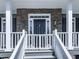 Elegant front entrance with a stone facade and a classic black door at 423 Eagle Ridge Trl, Canton, GA 30114