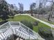 View from deck, showing lush green front yard with mature trees, and winding driveway at 423 Eagle Ridge Trl, Canton, GA 30114