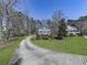 Inviting front yard with a long driveway leading to a charming two-story home at 423 Eagle Ridge Trl, Canton, GA 30114