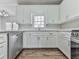 Bright kitchen featuring white cabinets, stainless steel dishwasher and a window at 423 Eagle Ridge Trl, Canton, GA 30114