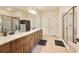 Bright bathroom with double vanity, granite countertops, framed mirrors, and a glass-enclosed shower at 4540 Brighton View Trl, Cumming, GA 30040