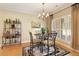 Charming dining area with a chandelier, ornate decorations, and large windows with shutter shades at 4540 Brighton View Trl, Cumming, GA 30040