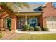Inviting brick home with a stone-accented porch featuring a quaint seating area and pleasant curb appeal at 4540 Brighton View Trl, Cumming, GA 30040