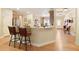 Open concept kitchen view showcasing the eat-in bar, dining area, and wood floors at 4540 Brighton View Trl, Cumming, GA 30040