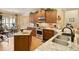 Well-lit kitchen featuring stainless steel appliances, granite countertops, an eat-in bar, and wood cabinets at 4540 Brighton View Trl, Cumming, GA 30040