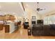 Open-concept living room with vaulted ceilings, a stone fireplace, and abundant natural light at 4540 Brighton View Trl, Cumming, GA 30040