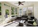 Bright sunroom featuring multiple windows offering serene backyard views and stylish seating arrangements at 4540 Brighton View Trl, Cumming, GA 30040