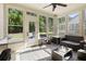 Inviting sunroom with large windows, a stylish area rug, and comfortable seating for relaxation at 4540 Brighton View Trl, Cumming, GA 30040