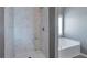 Modern bathroom featuring shower and soaking tub at 1515 Summer Lake Ter, Loganville, GA 30052