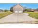 Attached two-car garage with a wide driveway and large backyard at 1515 Summer Lake Ter, Loganville, GA 30052