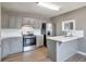 Well-equipped kitchen with stainless steel appliances and light gray cabinetry at 1515 Summer Lake Ter, Loganville, GA 30052