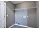 Compact laundry room with washer hookups and storage shelf at 1515 Summer Lake Ter, Loganville, GA 30052