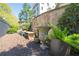Landscaped backyard space with stone benches, potted plants, and mature trees at 2500 Peachtree Nw Rd # 207S, Atlanta, GA 30305