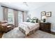 Comfortable bedroom with traditional decor, neutral colors, and a cozy chair at 2500 Peachtree Nw Rd # 207S, Atlanta, GA 30305
