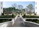 This idyllic courtyard with manicured greenery, brick pavers, and a fountain creates a picturesque and inviting outdoor space at 2500 Peachtree Nw Rd # 207S, Atlanta, GA 30305