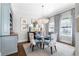 Beautiful dining room with crystal chandelier, floral chairs, and custom blue cabinet at 2500 Peachtree Nw Rd # 207S, Atlanta, GA 30305