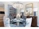 Chic dining area featuring a crystal chandelier, unique furniture, and a stylish bar area at 2500 Peachtree Nw Rd # 207S, Atlanta, GA 30305
