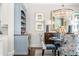 Chic dining area featuring a crystal chandelier, unique furniture, and custom blue cabinet at 2500 Peachtree Nw Rd # 207S, Atlanta, GA 30305