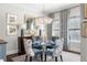 Elegant dining room showcasing a crystal chandelier, glass table, and stylish artwork at 2500 Peachtree Nw Rd # 207S, Atlanta, GA 30305