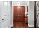 Inviting entryway featuring rich wood floors, paneled doors, and a decorative console table at 2500 Peachtree Nw Rd # 207S, Atlanta, GA 30305
