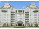 Luxury condominium with multiple balconies, manicured landscaping, and circular driveway at 2500 Peachtree Nw Rd # 207S, Atlanta, GA 30305