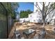 Outdoor garden area with gravel, raised planting beds, metal chairs, and a table offers a serene retreat at 2500 Peachtree Nw Rd # 207S, Atlanta, GA 30305