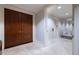 Bright hallway with marble floors, double doors, and bench seat with decorative mirror at 2500 Peachtree Nw Rd # 207S, Atlanta, GA 30305