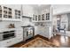 Well-lit kitchen with white cabinets, stainless appliances, marble countertops, and hardwood flooring at 2500 Peachtree Nw Rd # 207S, Atlanta, GA 30305