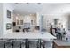 Modern kitchen featuring a large island, elegant lighting, and an open view to the dining area at 2500 Peachtree Nw Rd # 207S, Atlanta, GA 30305