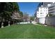 Expansive grassy lawn with a view of a pool and upscale apartments, perfect for relaxation and outdoor activities at 2500 Peachtree Nw Rd # 207S, Atlanta, GA 30305