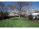 Lush lawn features mature trees and landscaping, offering a serene and picturesque outdoor setting at 2500 Peachtree Nw Rd # 207S, Atlanta, GA 30305