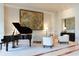 Modern living room featuring a grand piano and stylish seating around a large abstract painting at 2500 Peachtree Nw Rd # 207S, Atlanta, GA 30305