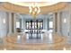 Elegant lobby featuring tall columns, a round table with flower arrangement, and modern chandelier at 2500 Peachtree Nw Rd # 207S, Atlanta, GA 30305
