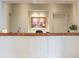 Reception desk with marble countertop and decorative wall art, creating a welcoming atmosphere at 2500 Peachtree Nw Rd # 207S, Atlanta, GA 30305