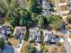 An aerial view of a home and a backyard pool next to a lake in a quiet neighborhood at 152 Vinings Lake Ct, Mableton, GA 30126