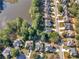 An aerial view of a home and a backyard pool next to a lake in a quiet neighborhood at 152 Vinings Lake Ct, Mableton, GA 30126