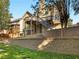 Spacious backyard with lush landscaping, retaining wall and stairs to upper deck at 152 Vinings Lake Ct, Mableton, GA 30126