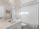 Neutral bathroom featuring a vanity, toilet, and a shower with a white shower curtain at 152 Vinings Lake Ct, Mableton, GA 30126
