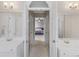 En suite bathroom with double vanities and hallway entrance to the main bedroom at 152 Vinings Lake Ct, Mableton, GA 30126