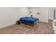Bedroom featuring a wood-look floor, blue blanket on bed, and neutral-colored walls at 152 Vinings Lake Ct, Mableton, GA 30126