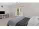 Comfortable bedroom with window, TV, neutral color scheme, and carpeted floors at 152 Vinings Lake Ct, Mableton, GA 30126