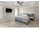 Modern bedroom featuring a large bed, ceiling fan, and neutral carpet at 152 Vinings Lake Ct, Mableton, GA 30126