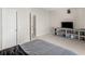 Inviting bedroom with a TV, neutral paint, carpeted floors and an open doorway at 152 Vinings Lake Ct, Mableton, GA 30126