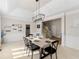 Open-concept dining area with modern lighting, neutral colors, and seating for four, great for intimate dinners at 152 Vinings Lake Ct, Mableton, GA 30126